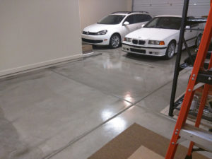 garage floor epoxy coating - 2 white cars in background