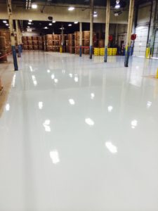 warehouse floor epoxy coating - brown boxes in background