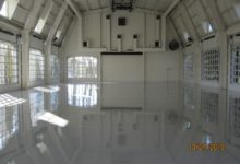 Thumbnail - Alan Jackson Garage - white large garage with at least 7 windowed garage doors